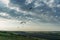 Parachutists gliding in blue sky over scenic landscape of Crimea, Ukraine,