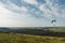 Parachutists gliding in blue sky over scenic landscape of Crimea, Ukraine,