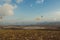 Parachutists gliding in blue sky over scenic landscape of Crimea, Ukraine,