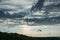 Parachutists gliding in blue sky over scenic landscape of Crimea, Ukraine,