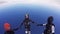 Parachutists jump from airplane, make formation in sky. Holding hands. Skydiving