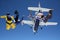 Parachutists jump from the plane