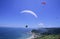 Parachutists over beach