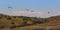 Parachutists on paragliders fly over the mountains