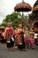 Parade of Balinese people with umbrella