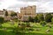 Parade Gardens in Bath, Somerset, England with people relaxing sunbathing on deckchairs and Empire Hotel in the background