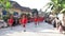 A parade with people wearing red attire showcases a vibrant and eye-catching scene