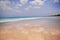 Paradise deserted wild beach and clouds reflected in coastal sand..