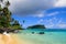 Paradise island tropical beach in Pacific Ocean with turquoise water, golden sand and exotic palm trees