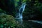 Paradise jungle forest with beautiful waterfall in green lush of Erawan park in Kanchanaburi, Thailand. Emerald pond and