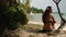 Paradise, Thai resort: woman admires of tropic seascape. Back view shot of young lady at sandy beach