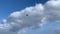 paraglide against a background of blue sky with clouds on a clear sunny day, 4k