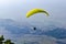 Paraglide silhouette flying over misty mountain