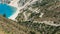 Paraglider above people enjoy the sun on the beach, Myrtos beach Kefalonia Greece