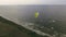 Paraglider in the air aerial shot. Man flies on a paraglider over a cliff. Life.