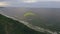 Paraglider in the air aerial shot. Man flies on a paraglider over a cliff. Life.