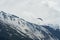 A paraglider in Alpine region with snowy slopes on the background. Scene from Engelberg region in Obwalden canton, Switzerland.