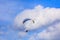 Paraglider in the blue sky with white clouds