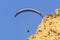 Paraglider blue sky and yellow sandstone cliff