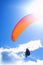 Paraglider on bright blue sky