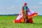 Paraglider carrying mattress flyer in meadow