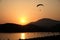 A paraglider coming into land at sunset olu deniz beach