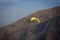 Paraglider flies in the mountains.