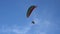 The paraglider flies overhead. Bottom view of a paraglider flying in the sky.