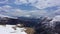 Paraglider flies among the snow-capped mountains