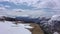 Paraglider flies among the snowy mountains of the Caucasus