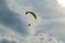 Paraglider flies into the sunset in summer