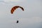 Paraglider flies into the sunset in summer