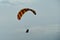 Paraglider flies into the sunset in summer