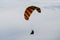 Paraglider flies into the sunset in summer