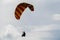 Paraglider flies into the sunset in summer