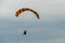 Paraglider flies into the sunset in summer