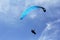 A paraglider flies towards the sky