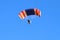 Paraglider flight against blue sky