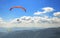 Paraglider floating in the air against the sky.