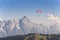 Paraglider flyes over mountains in Alps, Austria