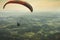 Paraglider flying on the beautiful sunny sky over the green mountains in PoÃ§os de Caldas