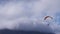 Paraglider flying through the clouds