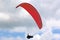Paraglider flying in a cloudy sky