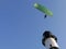 Paraglider flying a few meters over a lighthouse