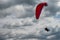 Paraglider flying over cloudy sky