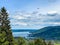 Paraglider flying over  lake. Paragliding under Bavarien landscape