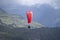 Paraglider flying over misty mountains