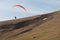 Paraglider flying over mountains