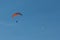 Paraglider flying over mountains in Italy