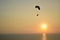 Paraglider flying over a sunset without people in the Pacific Ocean
